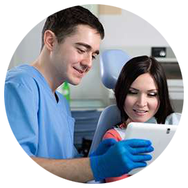 Dentist showing ipad to patient